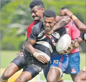  ?? Picture: ELIKI NUKUTABU ?? Red Wing 7s team rover Netani Nadavo holds up Samisoni Sadole of Sydney Nailaga in the quarter-finals of the Fiji Bitter Malomalo 7s.