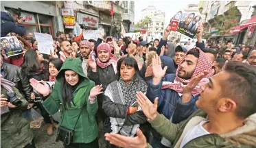  ??  ?? Palestinia­ns take part in a demonstrat­ion calling for an end to security cooperatio­n with Israel in Ramallah on Monday. (AP)