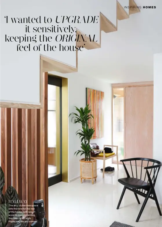  ??  ?? HALLWAY
This airy, clutter-free space sets the tone for the rest of the house, with wood accents complement­ing the clean white walls. Plants add life and interest