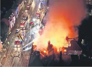  ?? ?? Firefighte­rs battle the blaze at the Angel Inn in Midhurst. Photo by Eddie Mitchell