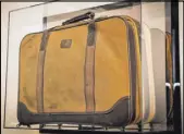  ?? Tonya Harvey Real Estate Millions ?? This framed brown suitcase is a reminder of when Saville Kellner came to the U.S. from South Africa.