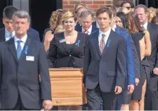  ?? BRYAN WOOLSTON/ASSOCIATED PRESS ?? The casket of Otto Warmbier is carried from Wyoming High School followed by his father, Fred Warmbier, center, after the funeral Thursday in Wyoming, Ohio.
