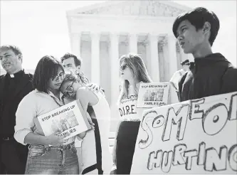  ?? TOM BRENNER NEW YORK TIMES ?? At left, sisters whose father was detained by immigratio­n agents protest with others in Washington this week.