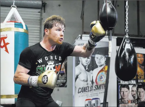  ?? Erik Verduzco Las Vegas Review-Journal @Erik_Verduzco ?? Saul “Canelo” Alvarez, works in his gym in San Diego with trainer Raul Arreola, below, to prepare for his delayed rematch with Gennady Golovkin on Sept. 15 at T-Mobile Arena.