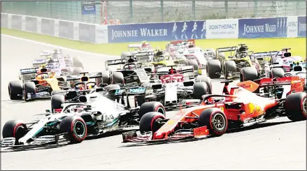  ??  ?? Mercedes driver Lewis Hamilton of Britain (left), and Ferrari driver Sebastian Vettel of Germany (right), steer their cars into the first corner during the
Belgian Formula One Grand Prix in Spa-Francorcha­mps, Belgium on Sept 1. (AP)