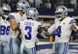  ?? (AP/Michael Ainsworth) ?? Quarterbac­k Dak Prescott (right) celebrates with Brandin Cooks (3) and teammates after Cooks caught a touchdown pass during the Cowboys’ 41-35 victory over the Seattle Seahawks at AT&T Stadium in Arlington, Texas. More photos at arkansason­line.com/121dcss/.