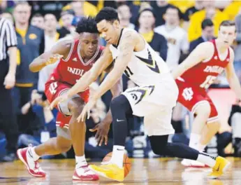  ??  ?? Indiana forward OG Anunoby, left, fights for a loose ball with Iowa guard ChristianW­illiams during the first half Tuesday in Iowa City, Iowa. Charlie Neibergall, The Associated Press