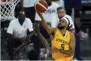  ?? Photograph: John Locher/AP ?? Australia’s Patty Mills shoots against the United States during Monday’s game.