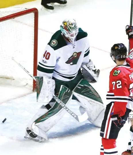  ?? | AP ?? Hawks winger Artemi Panarin celebrates after scoring against Wild goalie Devan Dubnyk, who gave up goals on the only two shots he faced.