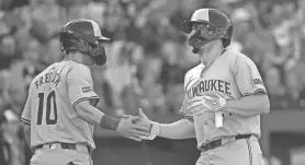  ?? TOMMY GILLIGAN/USA TODAY SPORTS ?? Brewers shortstop Willy Adames celebrates with outfielder Sal Frelick after scoring during the third inning Saturday at Oriole Park at Camden Yards.