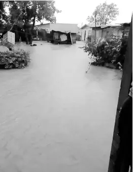  ?? PHOTO BY HOPETON BUCKNOR ?? Yards are flooded in Three Miles River, Westmorela­nd, as heavy rains pelted the parish over Christmas.