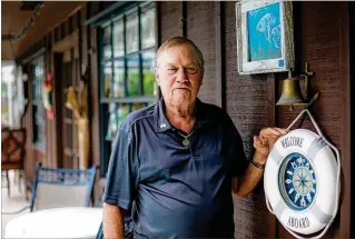  ?? RICHARD GRAULICH / THE PALM BEACH POST ?? Brian Bobbitt, the original owner of the Manatee Queen, stands outside his home in Jupiter on July 6.