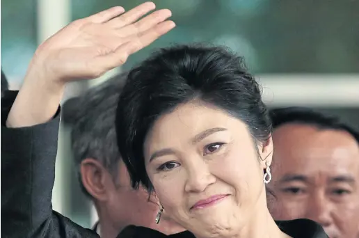  ?? PHOTOS BY PATIPAT JANTHONG ?? Ms Yingluck waves at a throng of supporters as she arrives at the Supreme Court’s Criminal Division for Holders of Political Positions on Chaeng Watthana Road for the last round of defence witness hearings in the rice-pledging case yesterday.