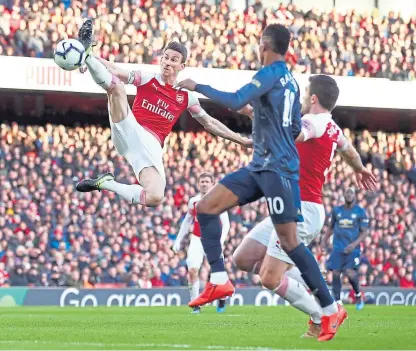  ?? Picture: Getty. ?? Arsenal defender Laurent Koscielny stretches to clear the ball from Marcus Rashford.