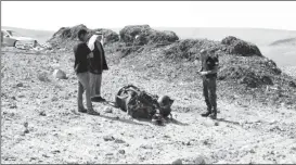  ?? ?? A police officer and residents inspect the remains of a rocket booster that, according to Israeli authoritie­s critically injured a 7-year-old girl, after Iran launched drones and missiles towards Israel, near Arad, Israel, April 14, 2024.