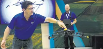  ?? Erik Verduzco ?? Jeffrey Lo, left, marketing manager for Intel, and pilot Andrew Georgopoul­os, give a demonstrat­ion of the Intel Falcon 8+ drone Wednesday.Las Vegas Review-journal