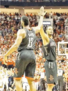  ?? — USA TODAY Sports photo ?? Houston Rockets’ James Harden (left) and Trevor Ariza celebrate during the fourth quarter against the Golden State Warriors at Toyota Center.