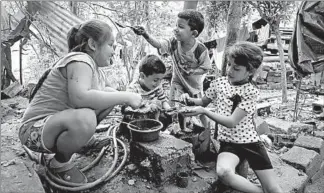  ??  ?? Jose Angel, 5, the younger child of Erik Castillo, second from left, plays with friends and relatives in La Mesilla, Guatemala. His older brother is still in the U.S. after being separated from his father, who was deported.