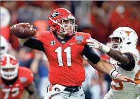  ?? / AP-Butch Dill ?? Georgia quarterbac­k Jake Fromm (11) passes under pressure from Texas defensive back B.J. Foster (25) during the first half of the Sugar Bowl in New Orleans on Tuesday.