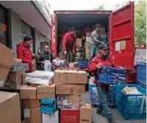  ??  ?? Deliveryme­n unload packages from a truck in Beijing ahead of the annual November 11 Singles Day shopping spree. — AFP photos