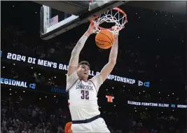  ?? STEVEN SENNE — THE ASSOCIATED PRESS ?? UConn center Donovan Clingan, who scored 22 points, dunks against Illinois during the first half of the NCAA Tournament Elite Eight game Saturday in Boston.