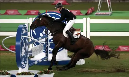  ?? ?? Annika Schleu of Germany struggles to control her Saint Boy in the Tokyo Olympics – the rider’s coach subsequent­ly punched the horse. Photograph: Iván Alvarado/Reuters