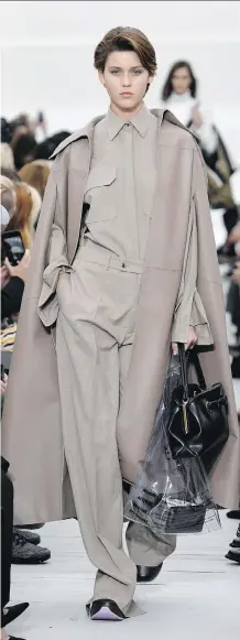  ?? BERTRAND GUAY/AFP/GETTY IMAGES ?? “Trench coats are a classic staple and are updated for spring with unexpected details and new proportion­s,” said Shannon Schafer, senior fashion director at Nordstrom.