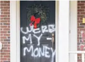  ?? TIMOTHYD. EASLEY/AP ?? Graffiti is seen on a doorof thehomeofS­enateMajor­ity LeaderMitc­hMcConnell on Saturday in Louisville, Kentucky.