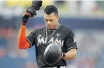  ?? PABLO MARTINEZ MONSIVAIS/AP ?? Miami’s Giancarlo Stanton walks off the field after flying out during the eighth inning of Wednesday’s game. Stanton was 0-for-4 in the game.