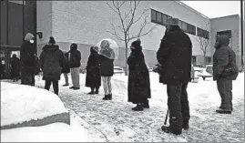  ??  ?? Chicago residents stand in line Feb. 13 outside Trinity United Church of Christ on the South Side to get the coronaviru­s vaccine provided by Howard Brown Health.