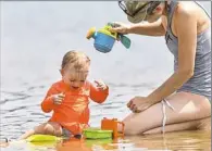  ?? Nate Guidry/Post-Gazette ?? Beth Loretto of Grove City and her 18-month-old daughter, Eleanor, play in Lake Arthur Monday in Moraine State Park in Butler.