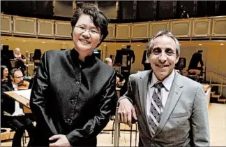  ?? TERRENCE ANTONIO JAMES/TRIBUNE 2015 ?? Chicago Sinfionett­a Executive Director Jim Hirsch, right, “really turned it around for us,” said his colleague, Music Director Mei-Ann Chen, left.