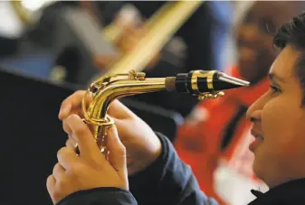  ?? Lea Suzuki / The Chronicle ?? Aaron Betanco, 13, assembles his saxophone during band class at Willie L. Brown Jr. Middle School in San Francisco in November as part of a course offered through SFJazz.