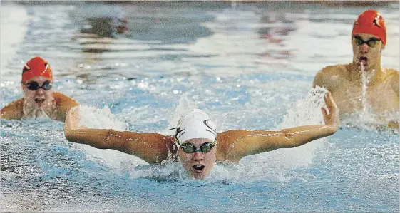  ?? CLIFFORD SKARSTEDT EXAMINER ?? Trent Swim Club swimmers Mackenzie Garside, 13, left, Rachel Chayer, 14, and Evan Feicic, 16, practise Wednesday at Trent University pool. Garside and Chayer have qualified for the Canadian Junior Swimming Championsh­ips.