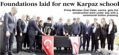  ?? ?? Prime Minister Ünal Üstel, centre, gets the constructi­on work under way with a ceremonial button pressing
