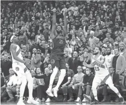  ?? AP ?? Raptors guard Fred VanVleet (23) and forward Precious Achiuwa (5) watch as 76ers center Joel Embiid sinks the game-winning 3-pointer in overtime of Game 3 of their first-round playoff series on Wednesday in Toronto.