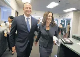  ?? Barbara Davidson Los Angeles Times ?? ATTY. GEN. Kamala Harris, right, and husband Douglas Emhoff reported having $1.5 million to $4 million in assets in 2015, not including their two homes.