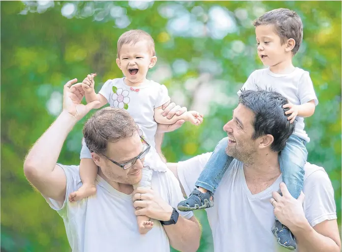  ??  ?? HAPPY FAMILY: Gordon Lake and Manuel Valero with their children Carmen and Alvaro, both born to surrogate parents. Alvaro has been sent back to Spain while his parents fight for custody of Carmen.