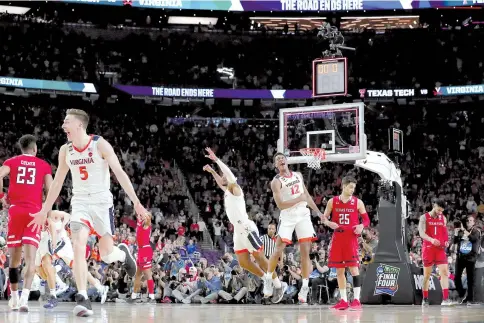  ?? — AFP photo ?? Kyle Guy #5 and De'Andre Hunter #12 of the Virginia Cavaliers celebrate their teams 85-77 win over the Texas Tech Red Raiders to win the 2019 NCAA men's Final Four National Championsh­ip game.