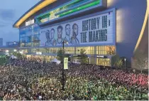  ?? Steve Megargee / Associated Press ?? Thousands of fans gather outside Fiserv Forum to watch on a video screen as the Bucks play at Phoenix in Game 1.