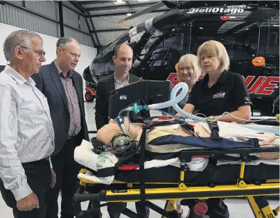  ?? PHOTO: LINDA ROBERTSON ?? Silver sponsors . . . After announcing a threeyear silver sponsorshi­p agreement between Network Waitaki and the Otago Rescue Helicopter Trust, paramedic Monica Aarsen (far right) demonstrat­es emergency equipment to (from left) HeliOtago chief pilot Graeme Gale, Network Waitaki chairman Chris Dennison, Network Waitaki chief executive Geoff Douch and Otago Rescue Helicopter Trust secretary/manager Vivienne Seaton.