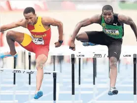  ?? RICARDO MAKYN/STAFF PHOTOGRAPH­ER ?? Wolmer’s Jaheel Hyde (left) and Calabar’s Michael O’Hara match strides as they head down the track in the final of the Class One boys’ 110m hurdles at Champs.