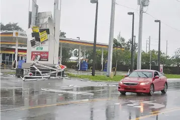  ??  ?? A gas station sign lays destroyed after Hurricane Irma blew though Fort Lauderdale, Florida, September 10.The combined economic cost of Hurricanes Harvey and Irma could reach US$290 billion, equivalent to 1.5 per cent of the US gross domestic product,...