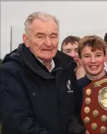  ??  ?? Pat Henderson presents the winning trophy to School, New Ross, after his side defeated Tullow