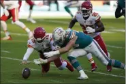  ?? WILFREDO LEE - THE ASSOCIATED PRESS ?? Kansas City Chiefs quarterbac­k Patrick Mahomes (15) and Miami Dolphins outside linebacker Andrew Van Ginkel (43) go after the football after Mahomes fumbled the snap, during the first half of an NFL football game, Sunday, Dec. 13, 2020, in Miami Gardens, Fla. The Chiefs recovered the ball.