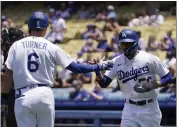  ?? ?? The Dodgers’ Mookie Betts, right, is congratula­ted by Trea Turner after scoring on a single by Freddie Freeman during the first inning against the Diamondbac­ks.