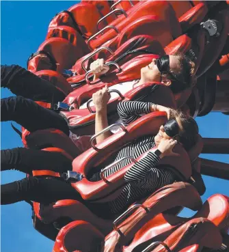  ?? Picture: STEVE HOLLAND ?? Tayla Dillion and Sean Curran on a blindfolde­d Dreamworld ride. GLEN NORRIS