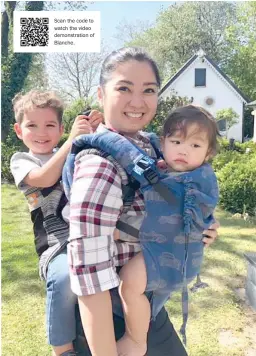  ??  ?? Writer and Certified Babywearin­g Consultant Blanche Pennings demonstrat­es how to carry her two boys securely in one go.