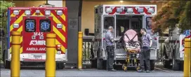  ?? JOHN SPINK/JSPINK@AJC.COM ?? First responders prepare their ambulance for another call Tuesday at Wellstar Atlanta Medical Center. As of Tuesday evening, the Georgia Department of Public Health was reporting 4,117 cases of COVID-19 and 125 deaths.