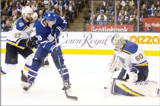  ??  ?? St Louis Blues goaltender Jordan Binnington (50) makes a save in front of Toronto Maple Leafs right wing Mitchell
Marner (16) during second-period NHL hockey game action in Toronto, on Oct 7. (AP)